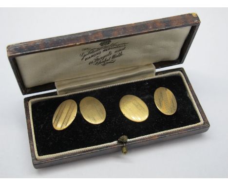 A Pair of 9ct Gold Gent's Cufflinks, the engine turned oval panels on chain connections, in a case. 