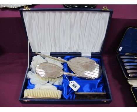 A Matched Hallmarked Silver Four Piece Dressing Table Set, Birmingham 1984, 1985, each with engine turned decoration, in a fi