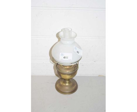 A small brass oil lamp with shade