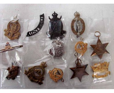 A collection of thirteen assorted military metal badges and medals including: Royal Canadian Ordnance Corps, Canadian Infantr