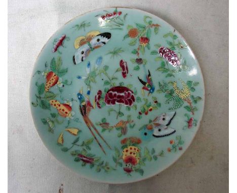 A Chinese celadon ground Dish decorated in famille rose colours with exotic birds and butterflies amongst flowering foliage, 