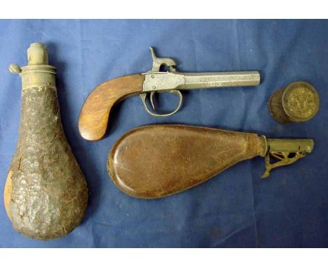A Continental pocket percussion pistol in full working order with period tin of percussion caps, leather shot flask and leath