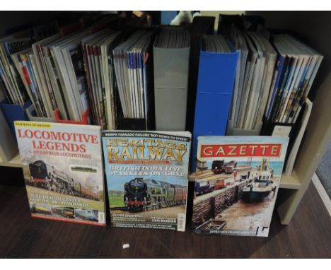 A shelf of modern O Guild Gazette, Steam Railway, Locomotive Legends and similar magazines