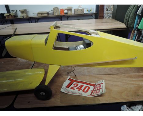 A wooden Precedent T240 radio controlled aeroplane having single cylinder engine, decal present but not applied, no control u