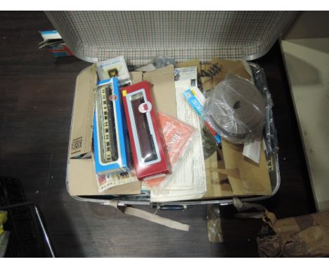 A suitcase of 00 gauge accessories, kits  and track including Peco, Ratio, Bachmann, Trix etc along with a Dapol wagon and a 