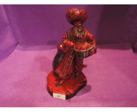 A Royal Doulton flambe figure, The Lamp Seller HN3278