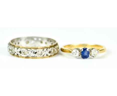 A Sapphire and Diamond Three Stone Ring, Modern, 18ct gold, set with a centre sapphire, approximately .25ct, flanked by two b