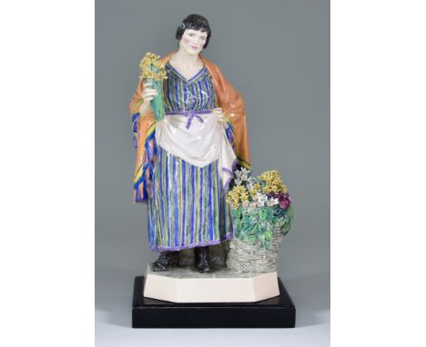 A Charles Vyse Pottery Figure - "The Daffodil Woman", circa 1925, modelled as a standing woman holding a bunch of daffodils i