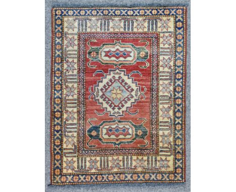 Two Modern Rugs of Kazak Design, each woven in colours of ivory, navy blue and wine, the fields filled with stylised floral a