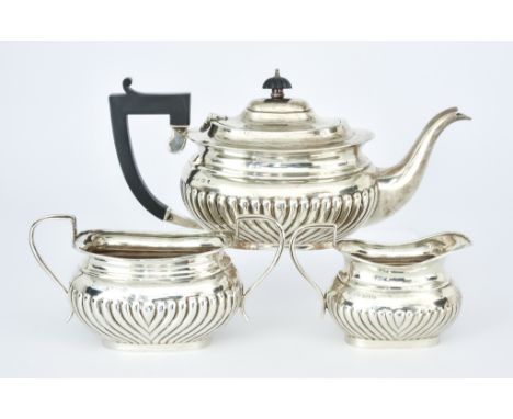 A George V Silver Rectangular Three Piece Tea Service, by Henry Matthews, Birmingham 1928, of rectangular form with part reed