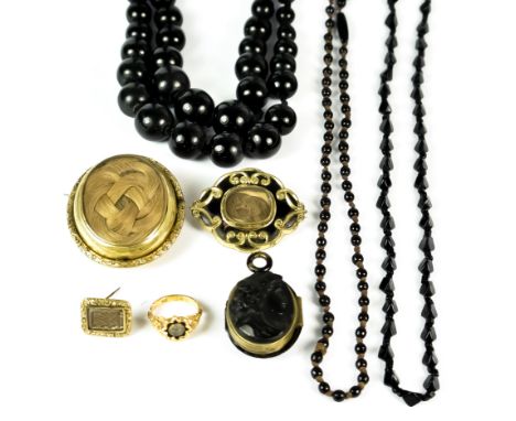 A Mixed Lot of Mourning Jewellery, comprising - a large double strand of jet beads, two smaller strands of jet beads, a carve