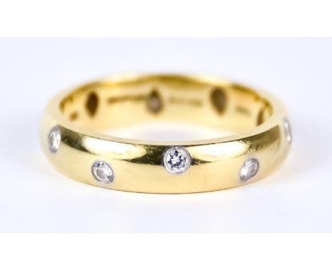 An 18ct Gold Wedding Band, Modern, by Tiffany &amp; Co., set with small diamonds, size K+, gross weight 4.6g