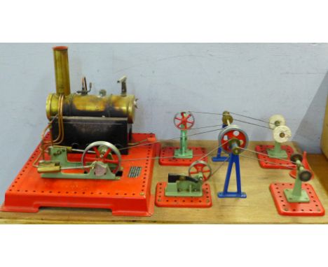 A Mamod twin cylinder super heated steam engine connected to a grinding machine, polishing machine, power press and power ham