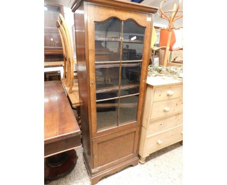 MID-20TH CENTURY WALNUT NARROW BOOKCASE WITH GLAZED DOOR WITH ADJUSTABLE SHELF OVER A SINGLE PANELLED DOOR ON BRACKET FEET   