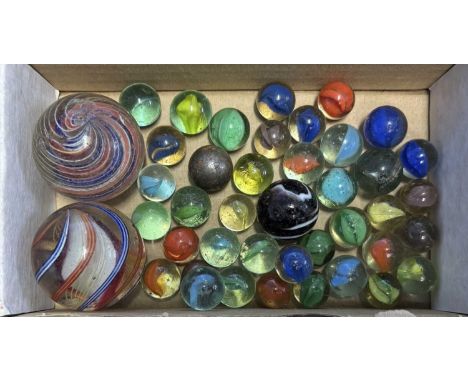 A collection of vintage glass marbles of various sizes