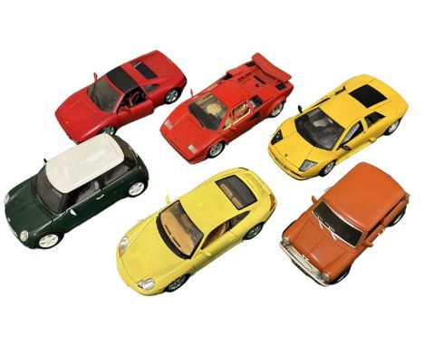 A collection of larger scale die cast model cars, mostly Bburago