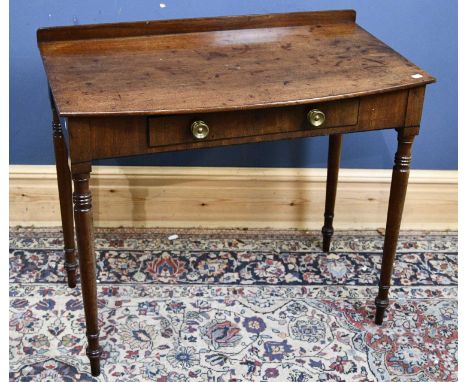 A 19th century mahogany bowfronted single drawer side table, on turned legs, height 79cm, width 89cm, depth 52cm.