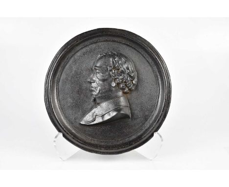 BENJAMIN DISRAELI, 1ST EARL OF BEACONSFIELD (1804-1881); a 19th century cast iron circular portrait plaque, cast with a bust 