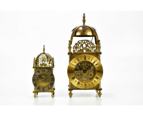 A 20th century German brass lantern clock, the applied dial set with Roman numerals, height 39cm, and a similar smaller examp