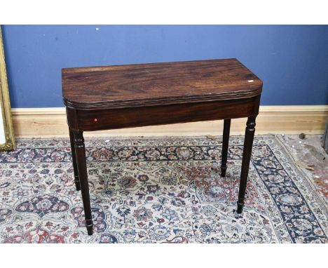 A 19th century mahogany fold-over tea table, height 72cm, width 90cm, depth 44cm.