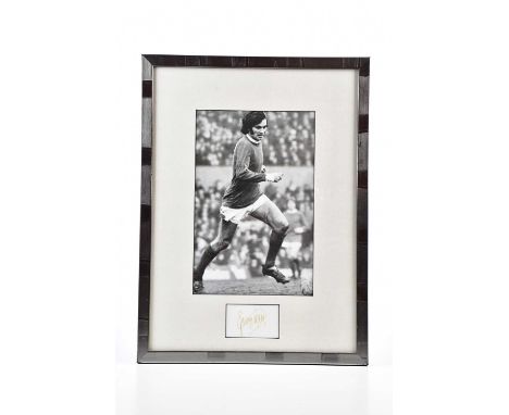 GEORGE BEST; a black and white image of George playing football, with a signature card, overall 43.5 x 31.5cm, framed and gla