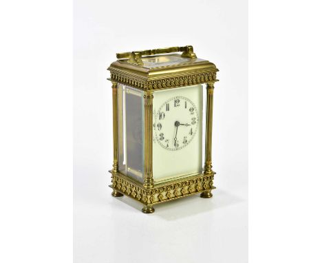 A 19th century brass cased carriage clock, the dial set with Arabic numerals, the brass case with applied floral decoration, 
