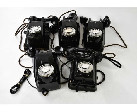 A collection of five bakelite rotary telephones