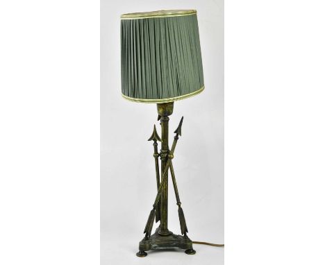 A modern brass desk lamp with rotating green glass shade and a modern table lamp modelled as three arrows.