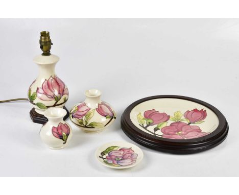 MOORCROFT; five pieces decorated in the 'Magnolia' pattern on ivory, including a baluster table lamp, height including fittin