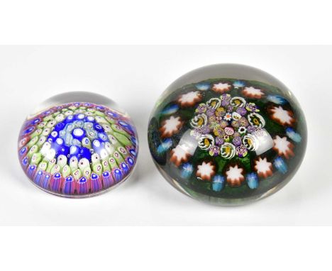 A 19th century millefiori decorated paperweight, diameter 6cm and a later paperweight with close cane work decoration, diamet