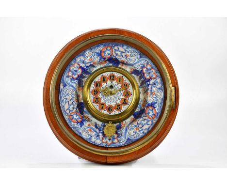 A Victorian ceramic wall charger with applied gilt metal and French ceramic time piece set with Arabic numerals, within a mah