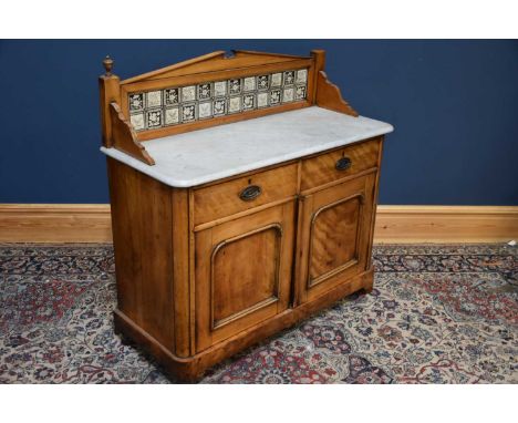 A Victorian satin walnut marble topped washstand, with tile back above two drawers and two doors on plinth base, width 111cm,