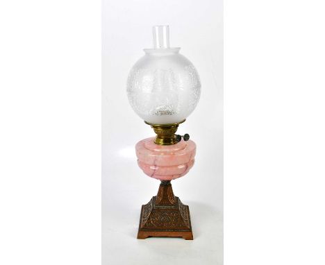 A pink marble effect hand blown 1930s oil lamp, with a copper finish, cast iron base, with brass twin wick burner, the galler