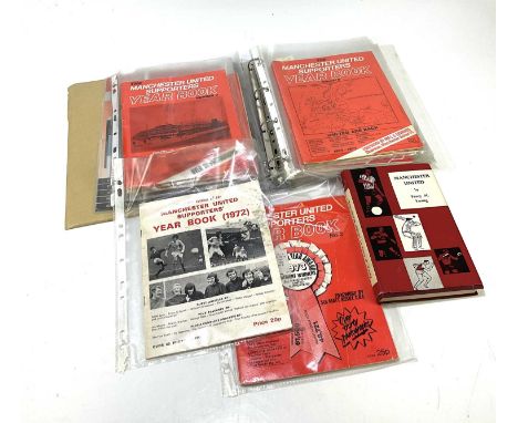MANCHESTER UNITED; an album containing various year books including 1977-78 signed, 1987-88, various voucher sheets, and a Ma