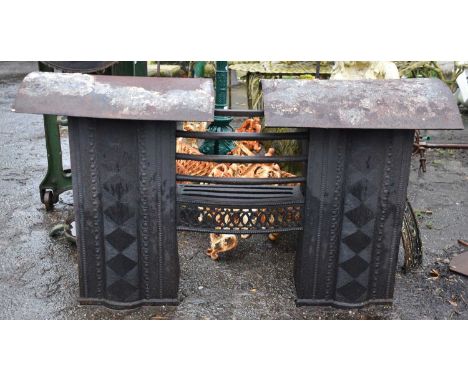 A cast iron fire grate, height 60cm, width 92cm, depth 31cm.