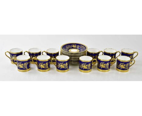 MINTON; a set of twelve blue and gilt coffee cups and saucers, with raised floral gilt detailing, (24).Condition Report: Ligh
