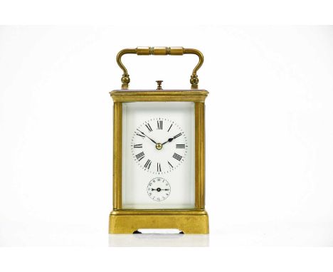 A late 19th century brass cased repeating carriage clock, the enamel dial set with Roman numerals and subsidary dial, height 