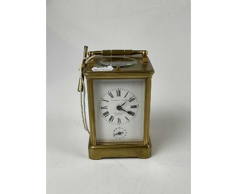 GOLDSMITHS COMPANY; a brass cased carriage clock, with white enamel dial set with Roman numerals and subsidiary dial, height 