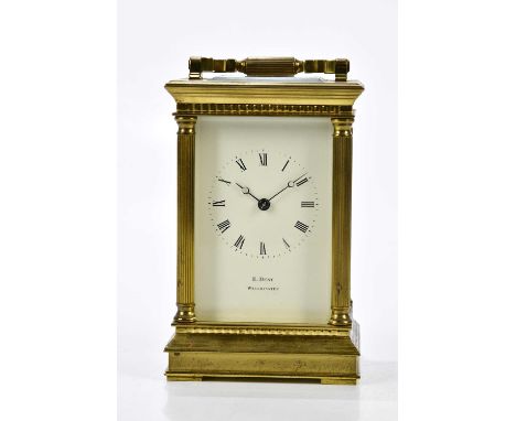 E. DENT, WESTMINSTER; a brass cased carriage clock, the enamelled dial set with Roman numerals flanked by four fluted columns