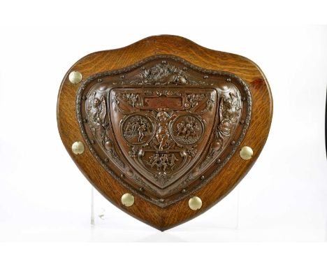 ELKINGTON &amp; CO; a bronzed metal shield shaped plaque, relief decorated with lion, angels and central cherub, with three c