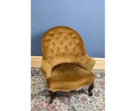 A Victorian button back armchair, on scrolling feet, height 85cm.