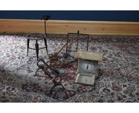 A collection of cast iron kitchen implements to include a rotisserie, a set of scales, etc.