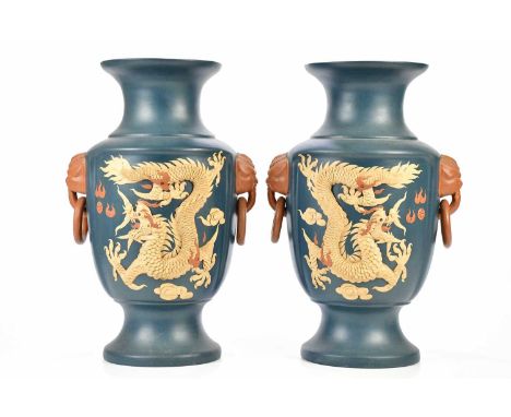 A large pair of contemporary Chinese Yixing vases with twin elephant mask ring drop handles and relief decoration depicting f