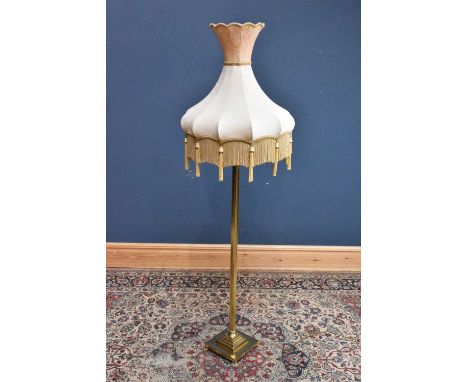 A modern brass Corinthian column standard lamp on paw feet, height including fitting 134cm.