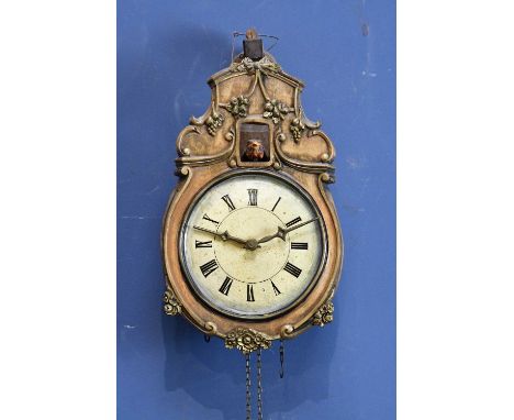 A 20th century Black Forest cuckoo wall clock, with arm striking on glass above the painted dial set with Roman numerals, wit