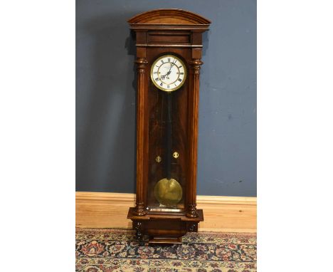 KRALIK SAMUEL PESTEN; a 19th century walnut cased Vienna style wall clock, with arched pediment above the enamel dial set wit