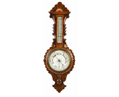 An early 20th century carved oak aneroid barometer.