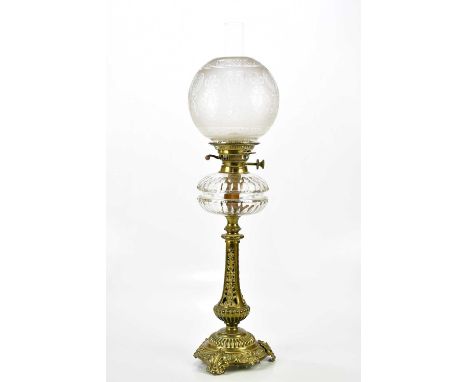 A Victorian oil lamp with etched glass shade above the cut glass reservoir and brass base, with pierced decoration, height in