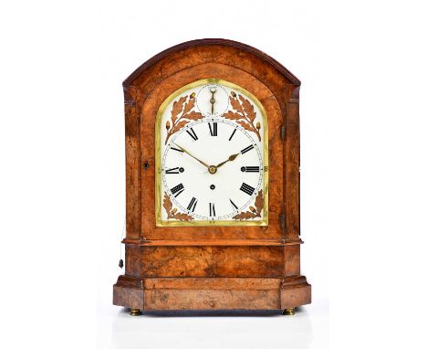 A 19th century burr walnut cased bracket clock, the arched top above the painted dial set with Roman numerals and silent/chim