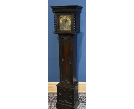 A mid 20th century chiming oak longcase clock of small proportions with brass dial set with Roman numerals, flanked by barley